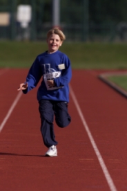 Boy racing down the track at the Mini Games
